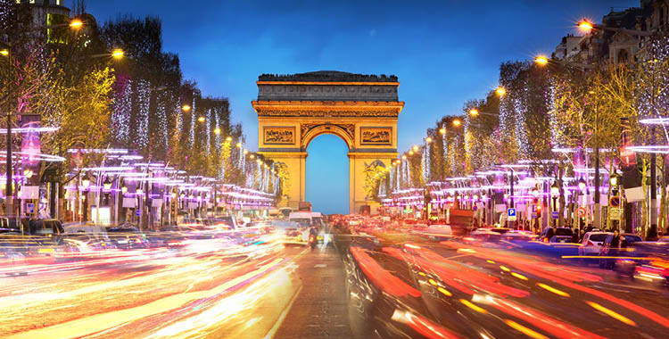 Traffic passing by at high speeds in front of the Arc De Triomphe in Paris, France.