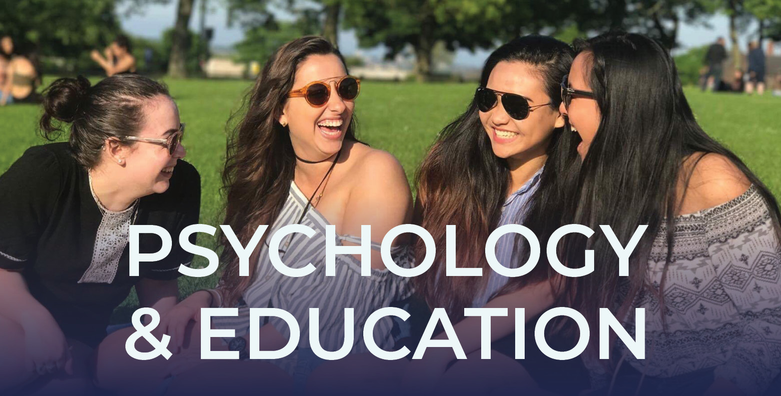 Four students laugh while seated on a lawn in Leeds, England. The words Psychology & Education are overlaid on the image.