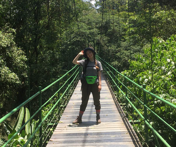 A student standing on a bridge in Costa Rica.